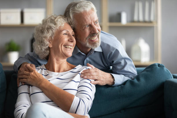 istock Smiling elderly couple look in distance dreaming 1212026825