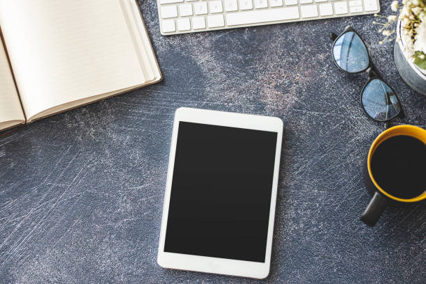 istock Keyboard, digital tablet and coffee on office desk 1212027245
