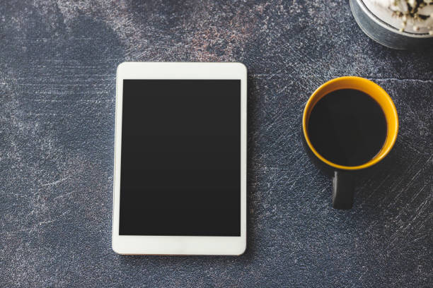 istock Digital tablet and coffee on office desk 1212027432