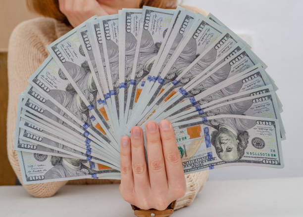 istock Hand holds american dollars spread out fan 1212028158