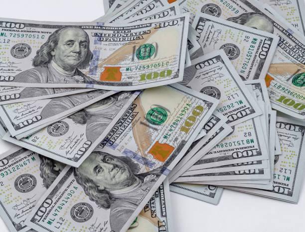 istock Scattered American dollars. Close-up on white background 1212028272