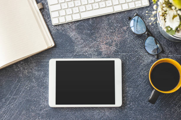 istock Keyboard, digital tablet and coffee on office desk 1212028379