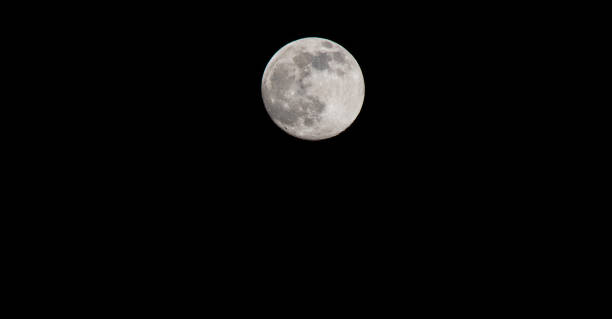 istock Closeup of a Full Moon in a Black Sky 1212028706