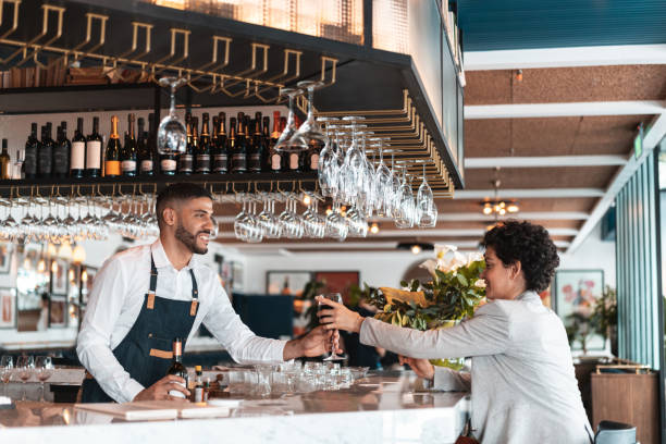 istock Waiter serving wine at restaurant 1212029714