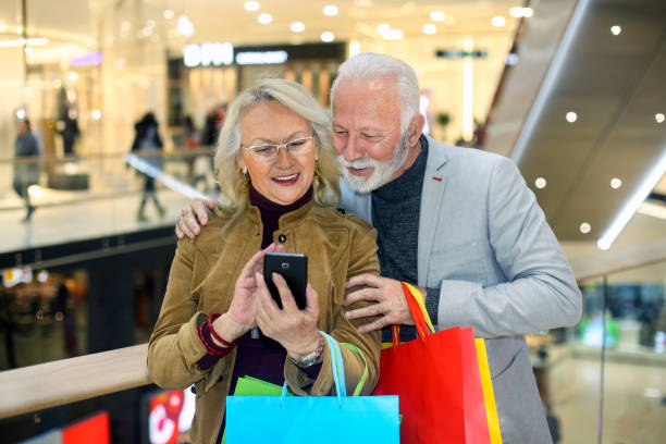 istock Senior couple using a mobile app in a shopping mall 1212030810