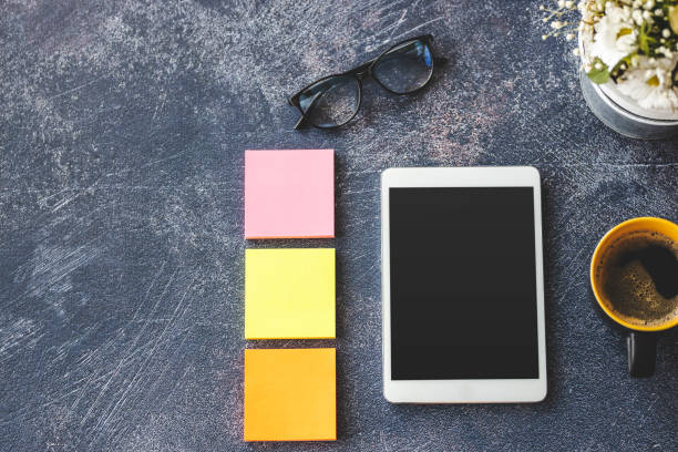 istock Digital tablet, notes, eyeglasses and coffee on office desk 1212031136
