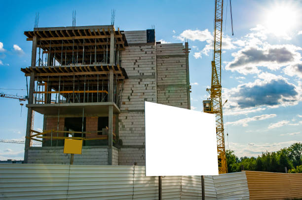 istock Blank white billboard for advertisement against the residential building under construction 1212031307