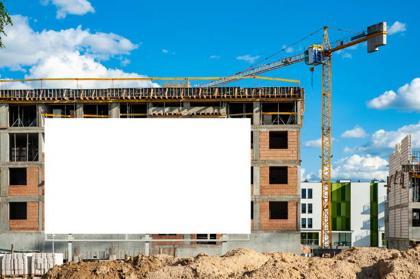 istock Blank white billboard for advertisement against the residential building under construction 1212031334