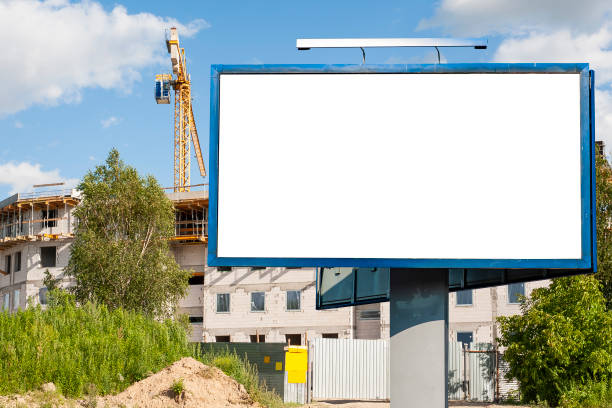 istock Blank white billboard for advertisement against the residential building under construction 1212031456