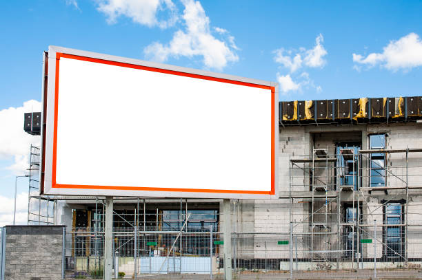 istock Blank white billboard for advertisement in the front of office building under construction 1212031462