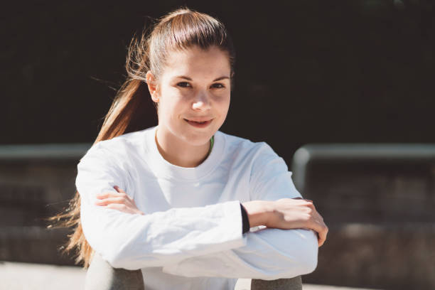 istock Woman with a pony tail sitting with crossed arms 1212033793