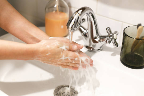 istock Washing hands. Hands washing under flowing water with proper technique and antibacterial soap in bathroom. Prevent coronavirus epidemic. Prevention of flu disease. 1212034332