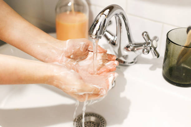 istock Washing hands. Hands washing with proper technique and antibacterial soap under flowing water in bathroom. Prevent coronavirus epidemic. Prevention of flu disease. 1212034434