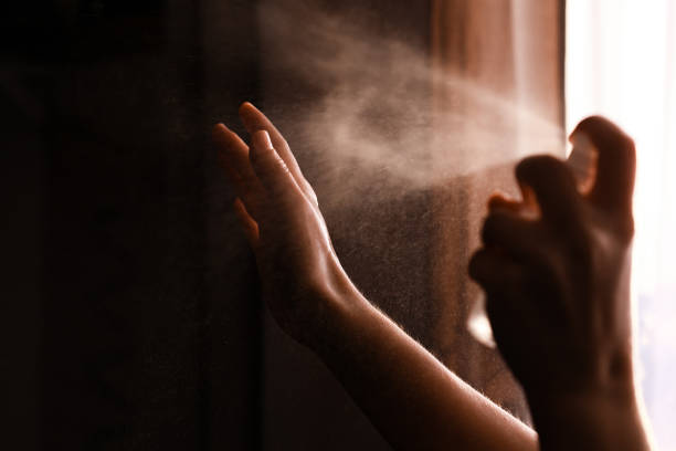 istock Disinfecting hands. Person using antiseptic spray on hands to  prevent coronavirus or flu disease. Personal hygiene. How to clean hands right. Wash your hands 1212034469