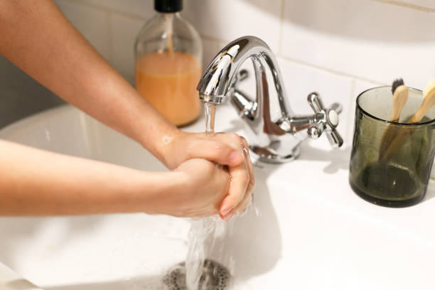 istock Washing hands under flowing water. Hands washing with proper technique and antibacterial soap in bathroom to Prevent coronavirus epidemic. Prevention of flu disease. 1212035427
