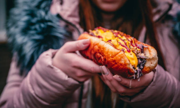 Philly cheese steak sandwich with meat, vegetables, cheese and sause in the hands of woman. Street food outdoor winter Philly cheese steak sandwich with meat, vegetables, cheese and sause in the hands of woman. Street food outdoor winter philadelphia winter stock pictures, royalty-free photos & images