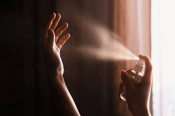 istock Disinfecting hands. Person using antiseptic spray on hands to  prevent coronavirus or flu disease. Personal hygiene. How to clean hands right. Wash your hands 1212035655