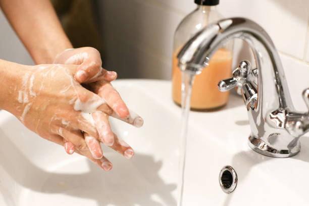 istock Washing hands. Hands washing with proper technique and antibacterial soap on background of flowing water in bathroom. Rubbing fingers. Prevent coronavirus epidemic. Prevention of flu disease. 1212035702