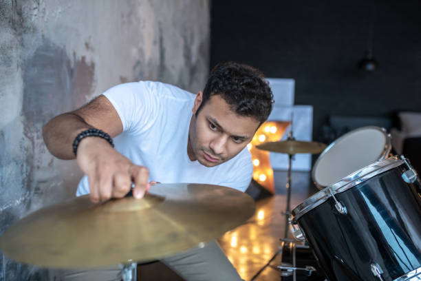 istock Dark-haired young man in a white tshirt looking involved 1212035764