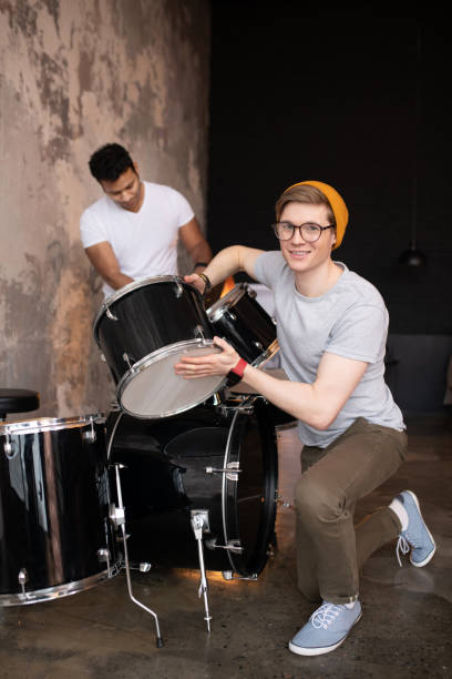 istock Young man in a red hat standing near the drums 1212035918