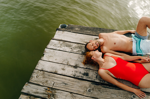 Photo of a young couple enjoying summer day on a lake