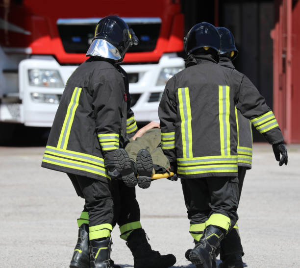 istock firefighters and a stretcher with person 1212036909