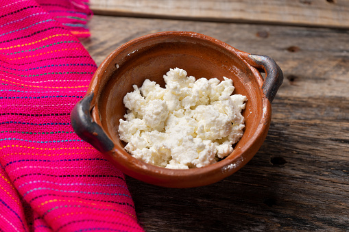 Traditional mexican panela cheese on wooden background