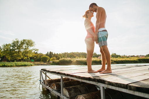 Photo of a young couple enjoying summer day on a lake