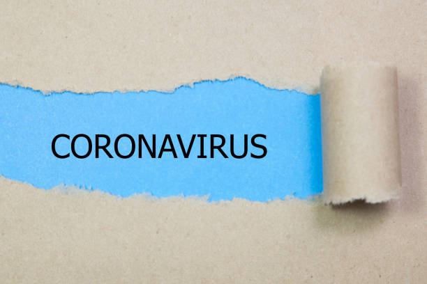 istock The word CORONAVIRUS appearing behind torn paper 1212038780