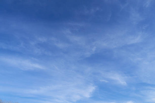 istock Bright beautiful blue sky with soft clouds for background or texture 1212039401