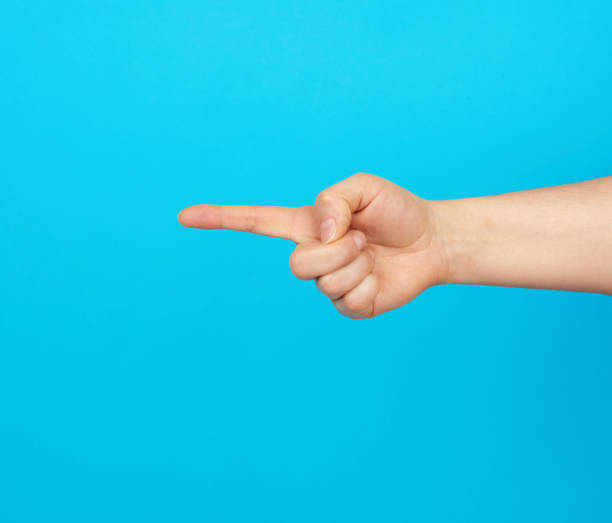 istock hand shows forefinger gesture on a blue background 1212040654