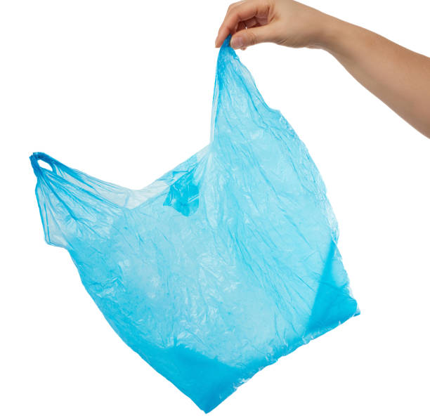 istock hand holds an empty blue plastic bag on a white background, concept of rejection of plastic 1212040849