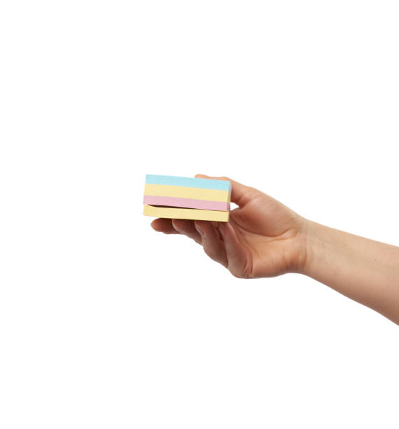 istock female hand and many empty paper multi-colored stickers 1212040951