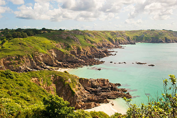 The rugged Britanny coast around Le Diben and Plougasnou in Northern France. Taken on a sunny day in late summer with a blue sky and light clouds from the coast path.