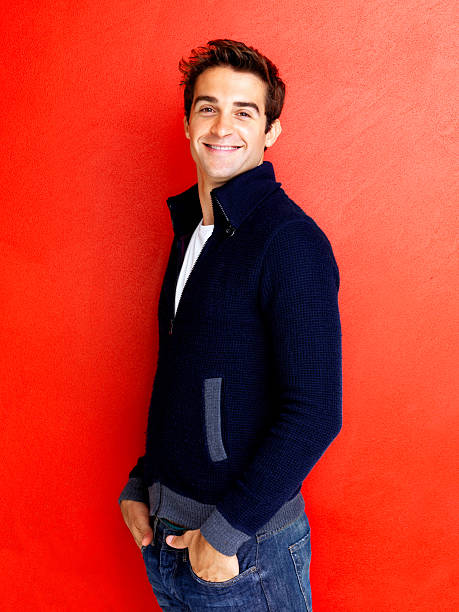 istock Stylish young man posing against red background 121204136