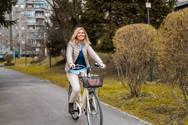 istock Woman riding a bicycle in a residential district 1212041982