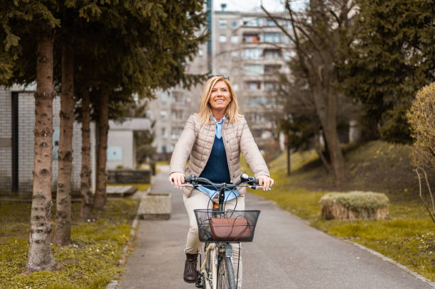 istock Woman riding a bicycle in a residential district 1212042006