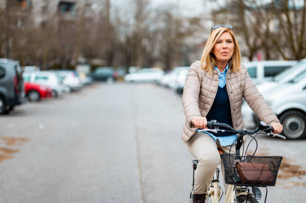 istock Woman riding a bicycle in a parking lot 1212042062
