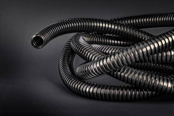 istock All black - Black flex tube on black background 1212042503
