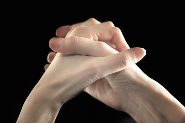 istock Close-up of two clasped hands 1212042543