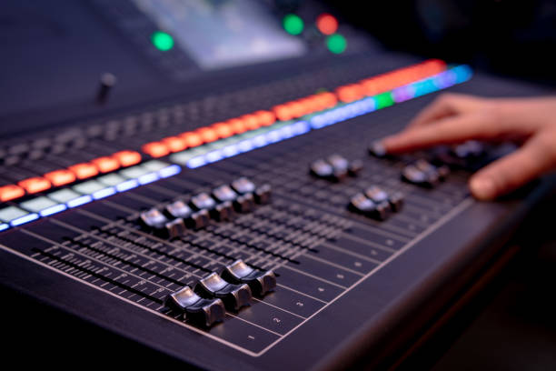istock Close up of audio mixing desk with blurred lights 1212043912