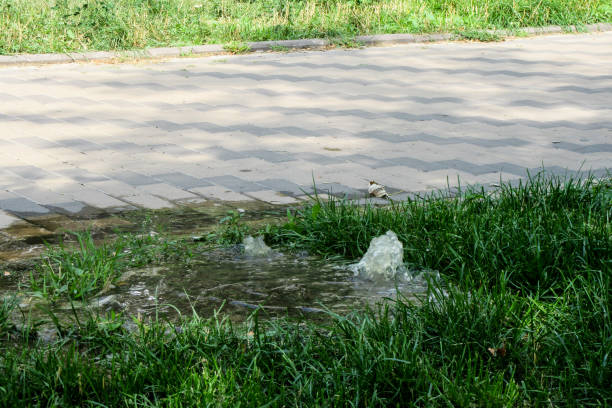 istock Accident sewerage system. Water flows over the road from the sewer. 1212045141