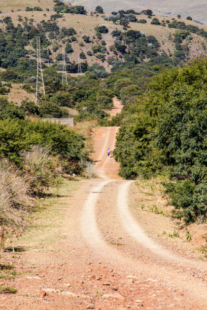 istock Dirt road over the hills 1212045187
