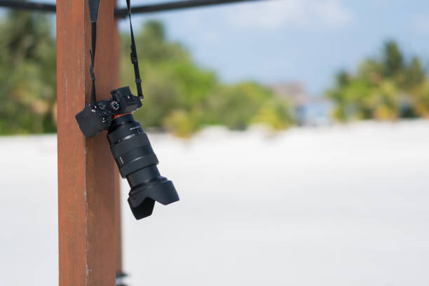 Foto camera hanging on the Maldive beach