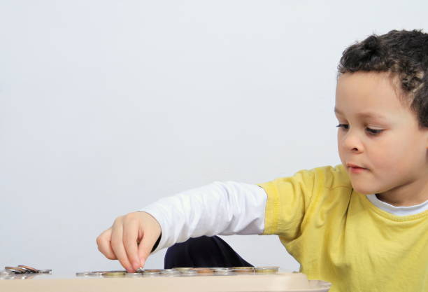 istock boy saving money stock photo 1212046207