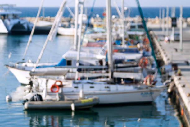 Blurred view of a sea harbor with moored yachts and boats