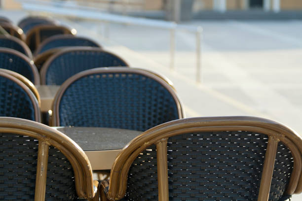istock Cafe tables and chairs on the street 1212046362