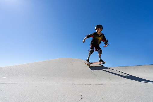 A young athletic boy skateboarding.