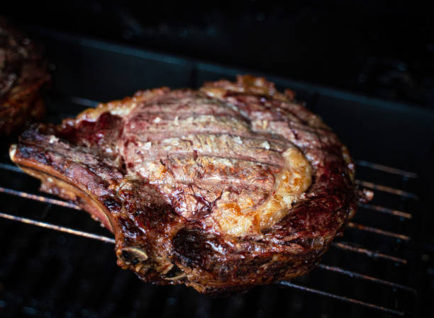 istock Bone in rib-eyes resting on the bbq 1212046760