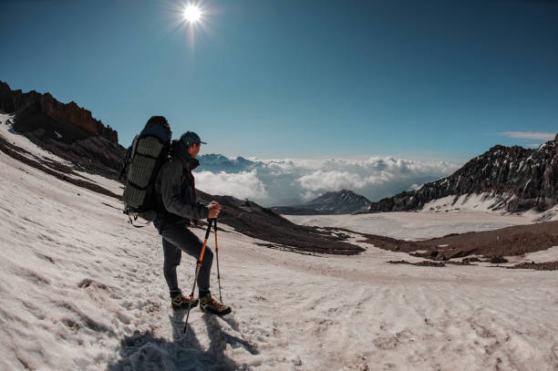 istock Male hiker stands on the mountain sides 1212049659